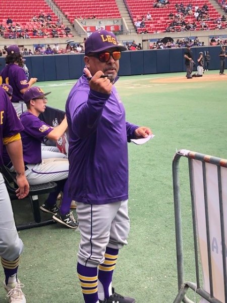 Lemoore High Coach Izzy Gonzalez watches the action from the dugout at Pete Beiden Field.